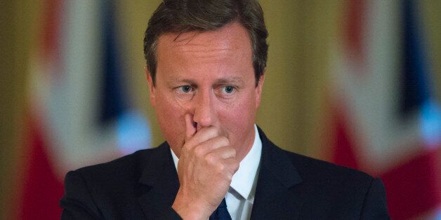 Prime Minister David Cameron pauses during a news conference in Downing Street, central London.