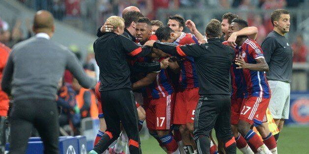 Bayern Munich's team members celebrate after Jerome Boateng (C) scored during the first leg UEFA Champions League Group E football match Borussia FC Bayern Munchen v Manchester City in Munich, Germany on September 17, 2014. AFP PHOTO / CHRISTOF STACHE (Photo credit should read CHRISTOF STACHE/AFP/Getty Images)