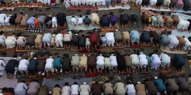 Pakistani Muslims offer Eid al-Fitr prayers at a ground in Karachi, Pakistan, Saturday, July 18, 2015. Eid al-Fitr marks the end of the holy month of Ramadan, during which Muslims all over the world fast from sunrise to sunset. (AP Photo/Fareed Khan)