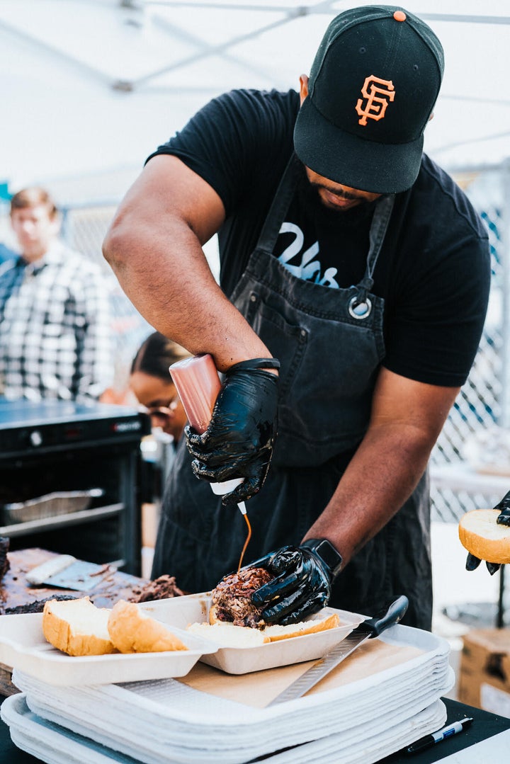 Matt Horn sauces the meat at Horn Barbecue in the Bay Area of Northern California.