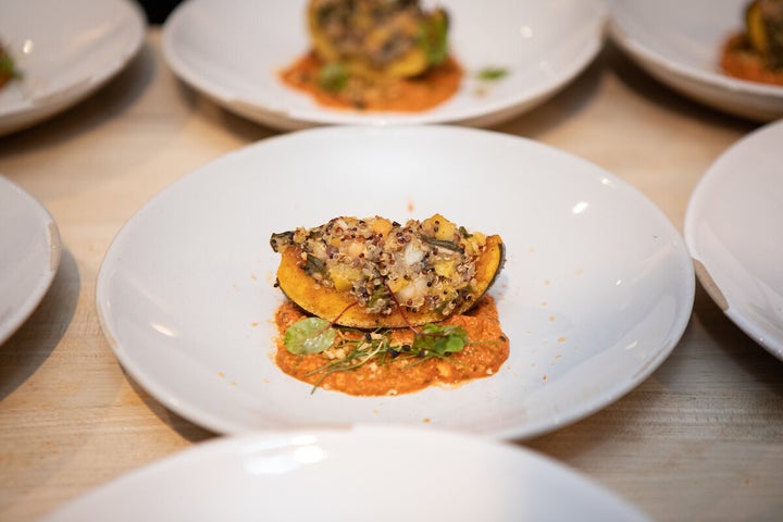 Roasted squash with collard greens, kuchela, creamed peas and preserved peach; romesco, and citrus-toasted bread crumbs.