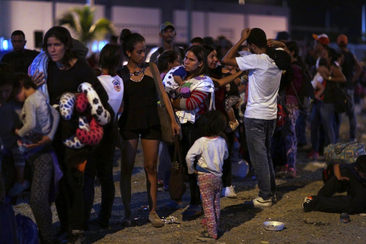 Venezuelans wait to pass immigration control at the Ecuador-Peru border -- late last week. Economic and political turmoil in