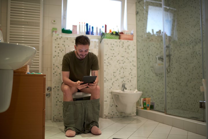 A new dad enjoys a lengthy visit to the bathroom while his partner silently packs his bags. 