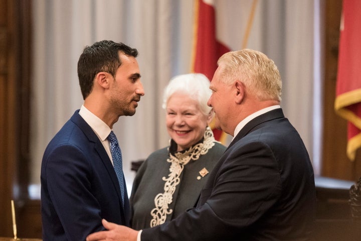 Ontario Premier Doug Ford shakes hands with Minister of Education Stephen Lecce at Queen's Park in Toronto on June 20, 2019.