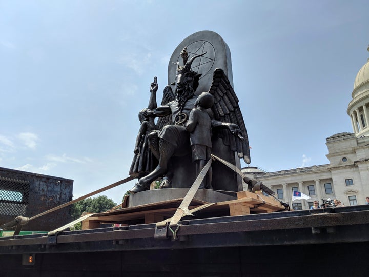 The Satanic Temple unveils its statue of Baphomet, a winged-goat creature, at a rally for the first amendment in Little Rock, Ark., Thursday, Aug. 16, 2018.