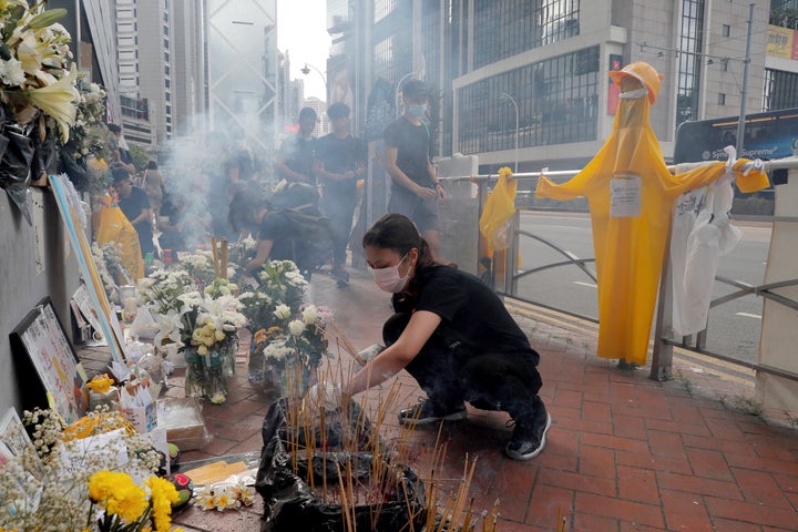 A makeshift memorial was created for a man who fell to his death last Saturday after hanging a protest banner.