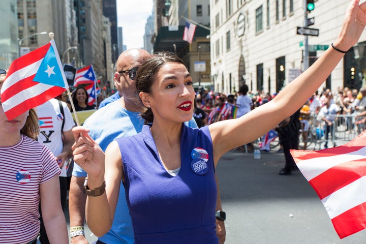 Rep. Alexandria Ocasio-Cortez (D-N.Y.) marches in the Puerto Rican Day Parade on June 9 in Manhattan. She has endorsed Cabán, a fellow Puerto Rican with a humble upbringing.