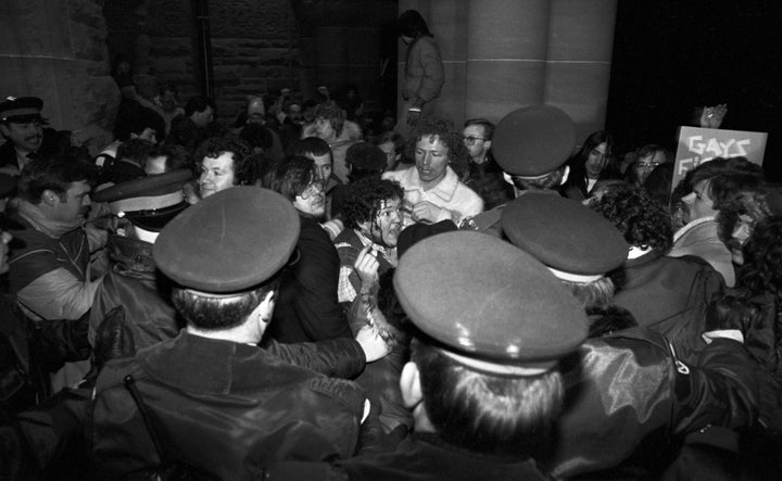 A man with blood streaming down his face scuffles with police outside the Ontario Legislature in Toronto on Feb. 6, 1981. About 1000 gay rights demonstrators marched there in protest of the arrests of 253 men in four city steam baths the night before.