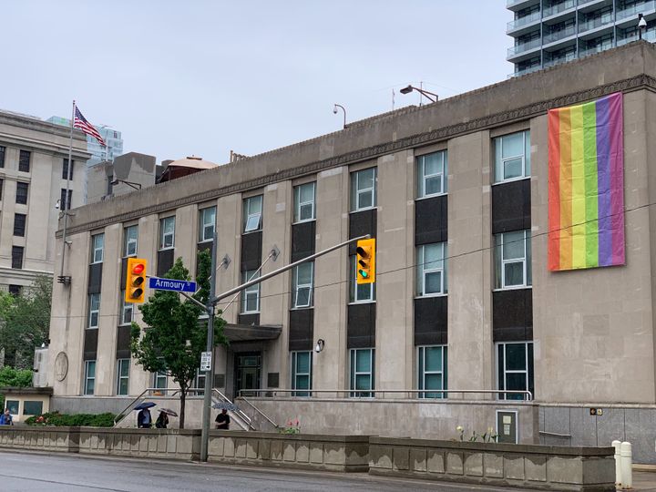 The Pride flag is draped over the U.S. consulate general building in Toronto.