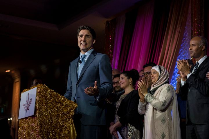 Trudeau is joined by members of the Liberal caucus while speaking at the Canadian Muslim Vote's Eid Dinner, in Toronto, on June 21, 2019.