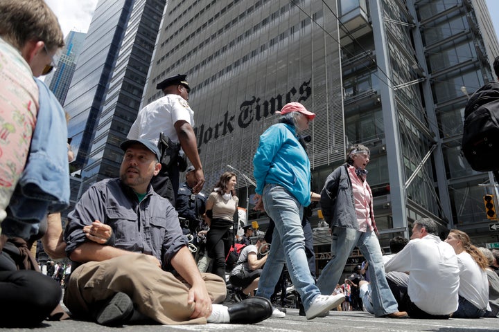 Activists sit on an intersection as others are taken into custody by New York Police officers during a climate change rally o