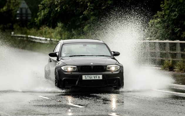 A car is driven through localised flooding near Leeming in Yorkshire.