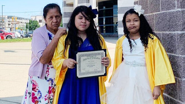 Alma Sofia Centeno Santiago's mother and 11-year-old daughter, center, at her fifth-grade graduation, along with one of the daughter's friends.