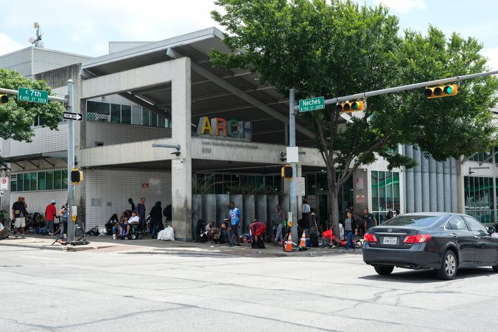 At the overburdened Austin Resource Center for the Homeless in downtown Austin, homeless people seeking shelter or services often spill into the streets. 