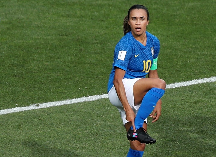 Brazil's Marta holds a Brazil's national jersey before making footprints of  her feet that will be placed on Brazil's Soccer Walk of Fame at the  Maracana stadium in Rio de Janeiro, Brazil