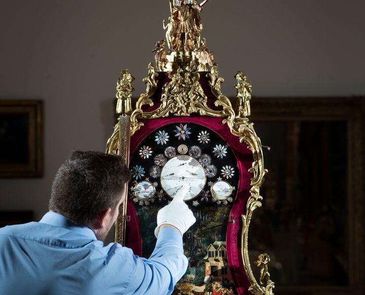 Steve Hearty Wells make adjustments to an ornate eighteenth-century clock at York Art Gallery in the U.K., ahead of daylight saving time.