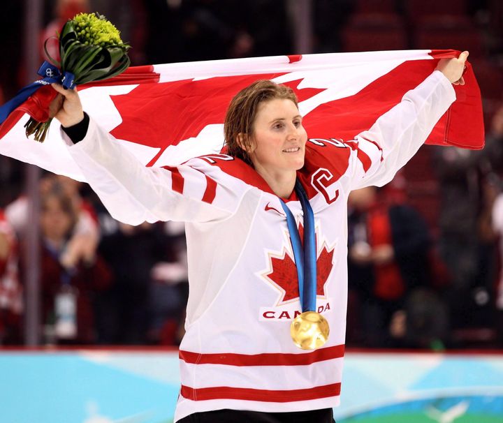 Hayley Wickenheiser hoists the Canadian flag after winning Gold at the 2010 Winter Olympics in Vancouver. 