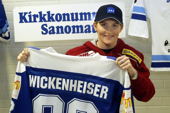 Hayley Wickenheiser holds up her jersey Kirkkonummen Salamat in 2003. 