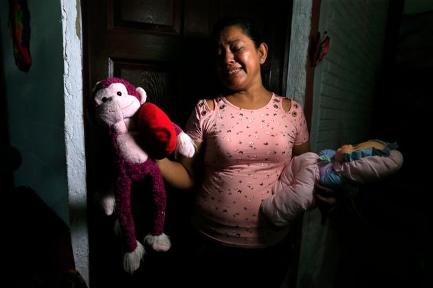 Rosa Ramirez sobs as she shows journalists toys that belonged to her nearly 2-year-old granddaughter Valeria in her home in San Martin, El Salvador.