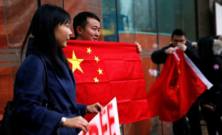 A man holds a Chinese flag outside the B.C. Supreme Court bail hearing of Huawei CFO Meng Wanzhou in Vancouver, Dec. 11, 2018.