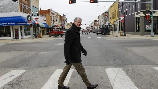 Attorney Thomas Maul crosses 13th Street in downtown Columbus, Nebraska. Maul headed the Nebraska State Bar Association in 20