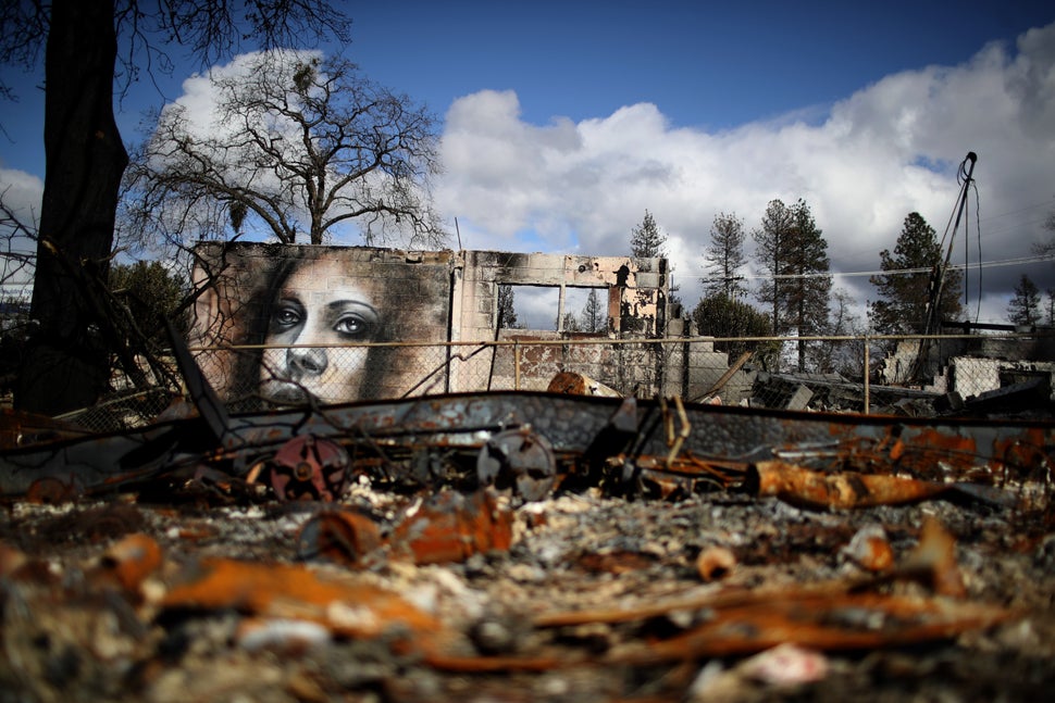 A mural by artist Shane Grammer is visible on the wall of a building destroyed by the 2018 wildfire that destroyed the town of Paradise, California. Climate change is leading to more intense and more frequent wildfires.