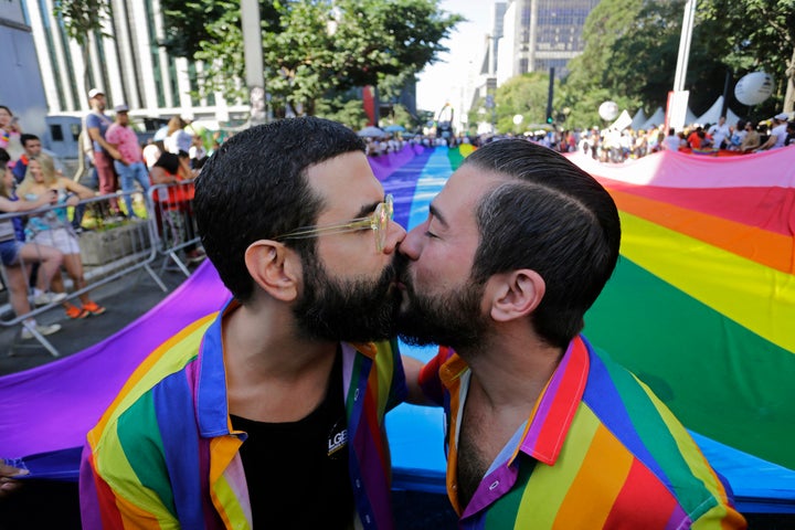 Two partners kiss during the Pride parade in São Paulo, which acted as a "confrontation with the policies" of right-wing President Jair Bolsonaro, who has pushed to roll back LGBTQ rights. 