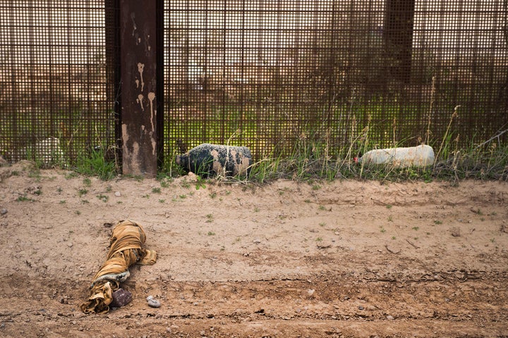 A swath of fabric and empty water jugs lay next to the border fence outside Lukeville, Arizona, on Feb. 16, 2017.