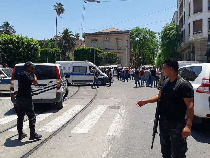Tunisian police officers stand guard near the explosion site in Tunis