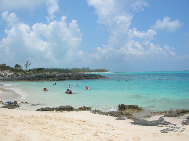 A 21-year-old woman has died after she was attacked by several sharks while snorkeling near Rose Island, pictured, in the Bah
