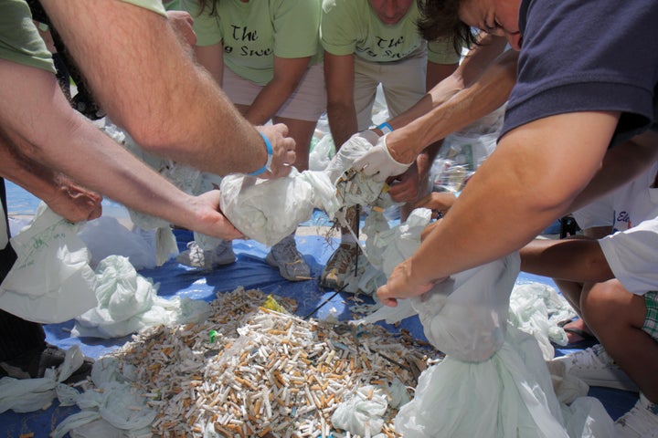 Volunteers fill bags with cigarette butts found on Miami Beach at the ECOMB Big Sweep Plastic a decade ago.