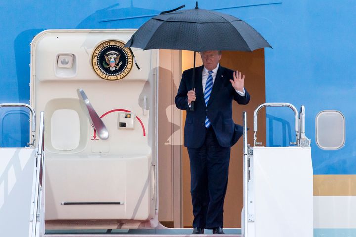 U.S. President Donald Trump waves as he arrives for the G-20 Osaka summit.
