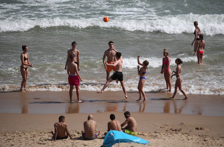 People play beach volleyball as they enjoy the warm weather on Bournemouth beach in Dorset on Thursday.