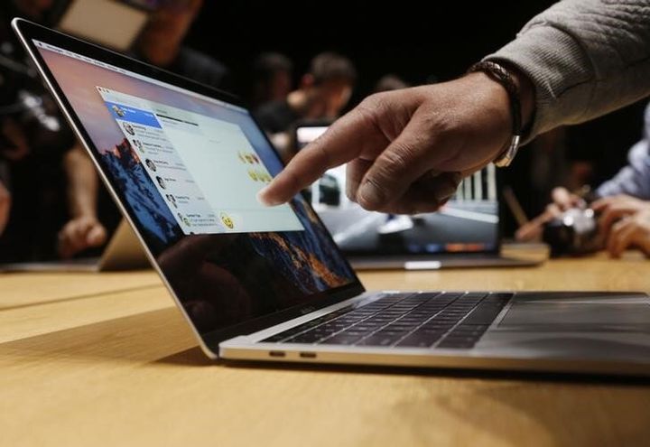 This photo from 2016 shows an Apple user pointing at the screen of a 15-inch MacBook Pro at a media event in California.