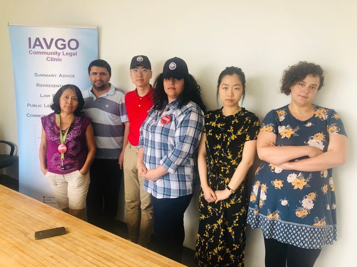 Employees at the Industrial Accident Victims Group of Ontario are taking a pay cut in an attempt to avoid layoffs. Staff Belia Berrocal and Sharif Mahboob, left, and Jenna Meguid, on the right, pose with law students Daniel Yang, Farnaz Talebpour and Linda Yang on June 28, 2019.