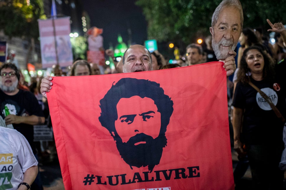 A supporter of former Brazilian President Luis Inacio Lula da Silva holds a flag during a national strike...