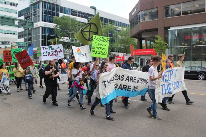 Protesters march through downtown Edmonton as part of the Student Climate March on June 28, 2019.