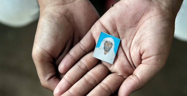 Irshad Khan holds a photo of Pehlu Khan who was killed by cow vigilantes in