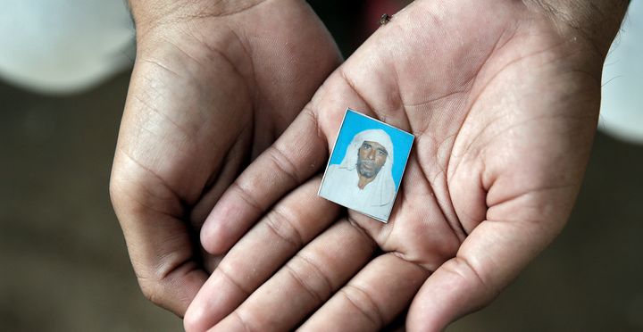Irshad Khan holds a photo of Pehlu Khan who was killed by cow vigilantes in 2017.