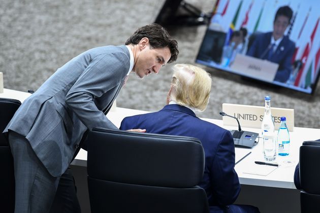 Prime Minister Justin Trudeau (L) speaks with President Donald Trump during the G20 Summit in Osaka on...