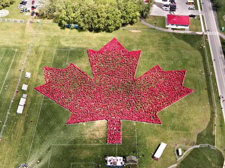 People wear red to form a giant maple leaf in Trenton, Ont. on Saturday.