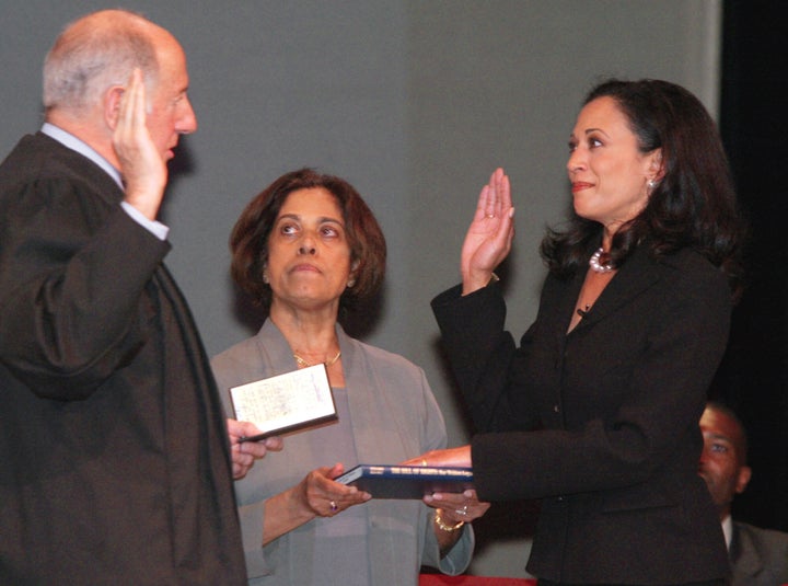 Kamala Harris, right, receives the oath of office on Jan. 8, 2004, in San Francisco. In the center is Harris' mother, Dr. Shyamala Gopalan, who holds a copy of "The Bill of Rights."