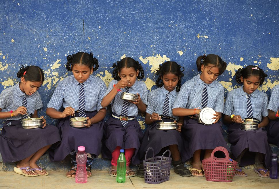 A file photograph of children eating their mid-day meal.