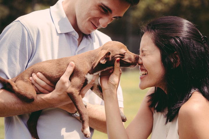 Setani gets a kiss on the nose from a puppy.