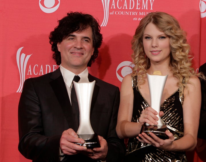 In this April 5, 2009 file photo, producer Scott Borchetta, left, and Swift pose with the Album of the Year award at the 44th Annual Academy of Country Music Awards.