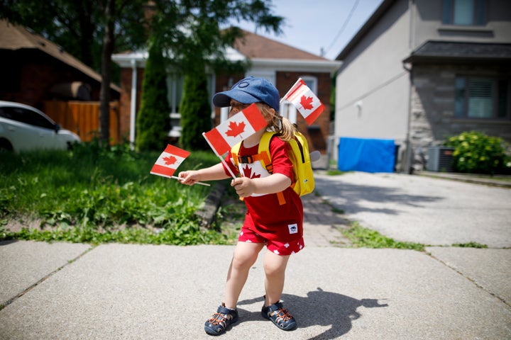 This little reveller, Blair, is just two years old, but is already maximizing her flag-and-maple-leaf capacity. And it looks like her hat has a "6" on it, perhaps repping Toronto?