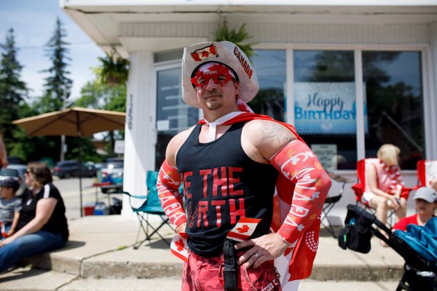 On second thought, parade-goer Sean Healy might be a match for that little flag-bearer. Here you'll notice his deft combining of traditional Canadian and Raptors motifs. Do his Canada armbands offer SPF protection though? We worry.