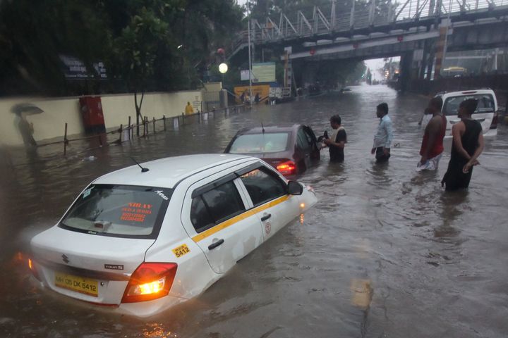 A taxi is seen stuck at a waterlogged street during heavy rains in Mumbai, on 1 July 2019. 