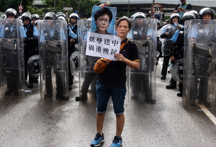 A protester holds a placard against Chief Executive of Hong Kong Carrie Lam during the demonstration and standoff with the police