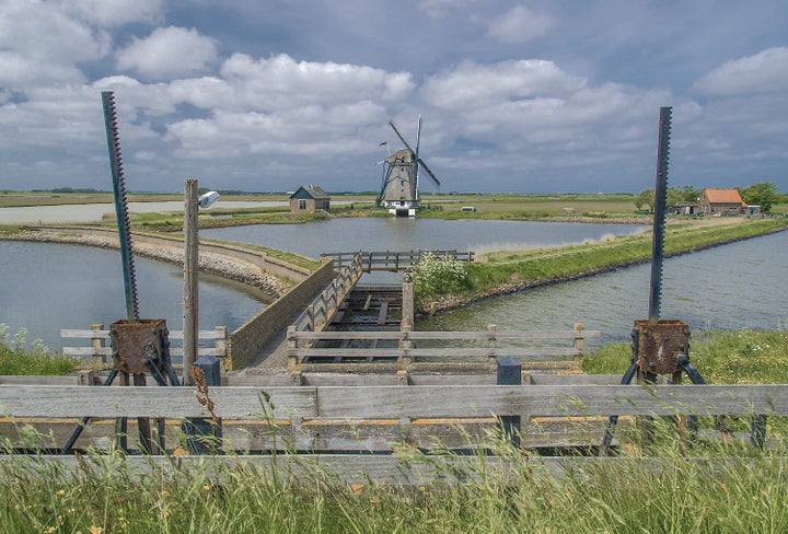 Over centuries, the Dutch reclaimed land by surrounding wetlands with dikes and then pumping the water out using windmills. This windmill, Het Noorden, on the Isle of Texel, was built in 1878 to reclaim land and keep it dry.